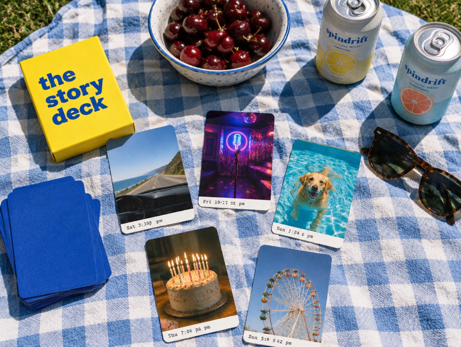 A deck of photo cards spread on a picnic blanket